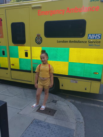 Ariana pictured by an ambulance.