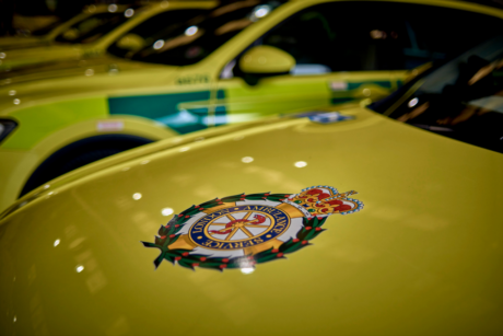 Decorative image showing the LAS crest on the bonnet of an ambulance car
