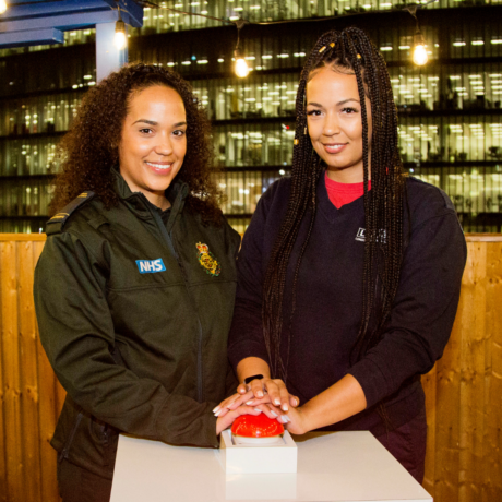 Siobhan and Shivaun with their hands on the red button ready to switch the lights on