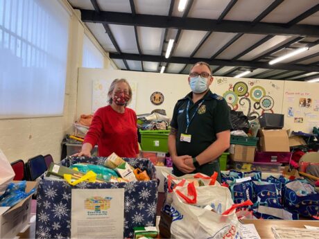 One of Nigel's colleagues helping the donations with donated food at food bank