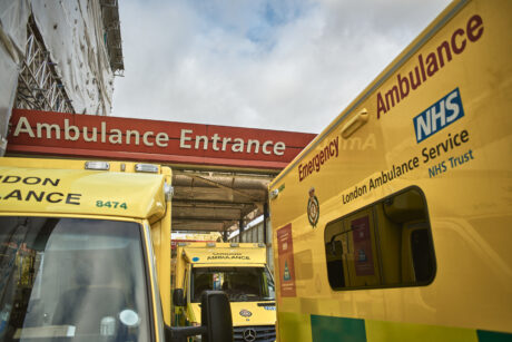 Ambulances parked in hospital bay with words Ambulance Entrance