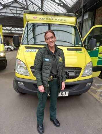 Carla photographed in her LAS uniform in front of an ambulance