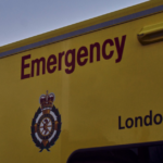 Archive image of the side of a LAS ambulance with the rear blue light flashing