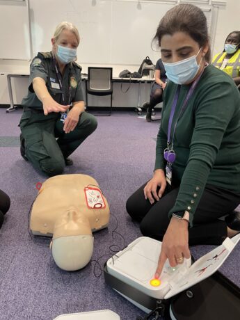 Medic demonstrates defibrillator
