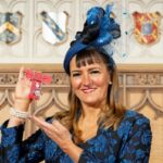 Amanda Mansfield holding her MBE inside Windsor Castle