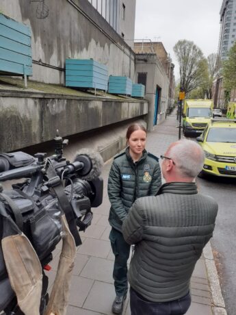 Eva speaking to BBC news about her experience on the humanitarian mission image shows Eva speaking to BBC team member and BBC camera crew filming towards Eva