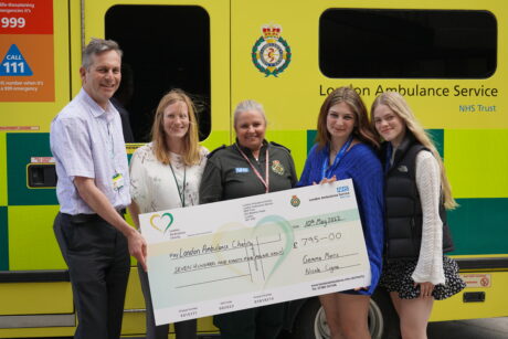 Gemma and Nicole hand over the fundraising cheque to CEO Daniel and Sally Head of Charity