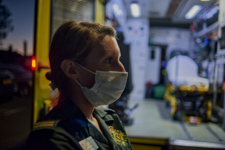 Nicola Jones, one of our Advanced Paramedic Practitioners in Urgent Care, standing at the back of an ambulance wearing a face mask, with the interior of the ambulance visible.