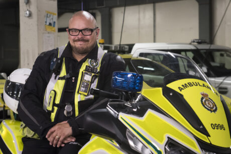 Richard Webb-Stevens next to his motorcycle