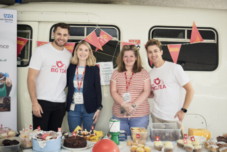 Aj and Curtis at the cake sale with volunteers