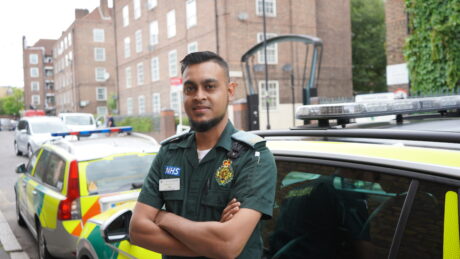 ER Ali standing in front of emergency response cars