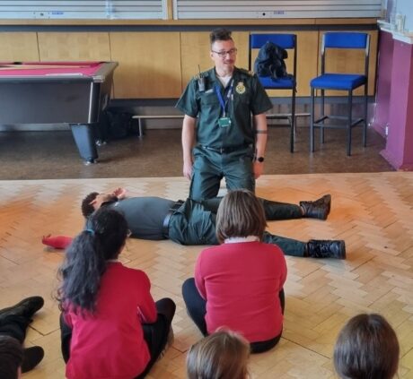 Public education member of staff giving a demonstration to pupils at school