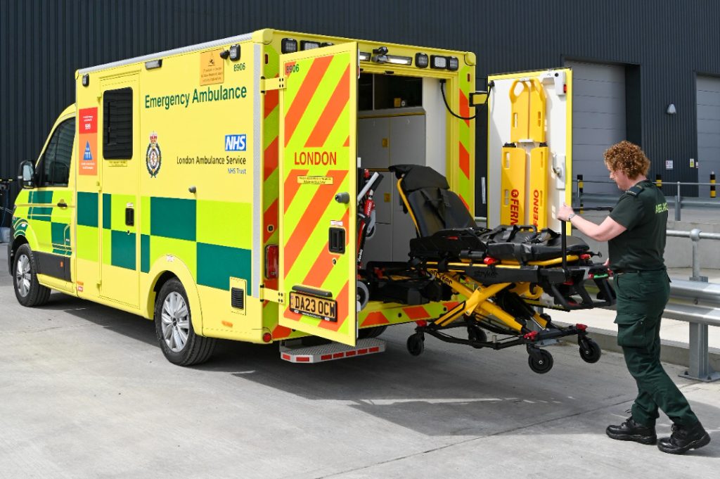 A picture of paramedic Dawn loading a patient stretcher on a new MAN ambulance. 