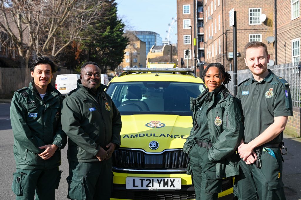 A photo of four mental health specialist clinicians standing by a fast-response car. 