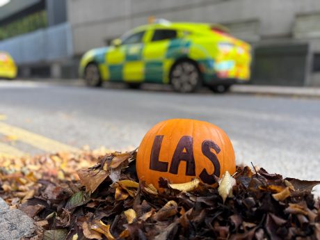 Pumpkin with backdrop of London Ambulance Service response car at Waterloo Road HQ
