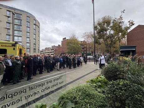 London Ambulance Service staff mark the two minutes silence in the memorial garden at Waterloo Road HQ