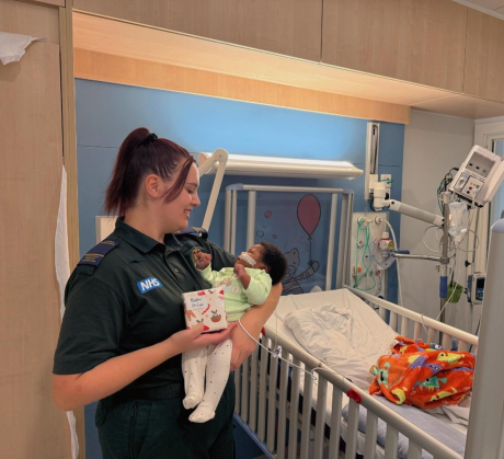 Baby Daniella with Ellie receiving a gift
