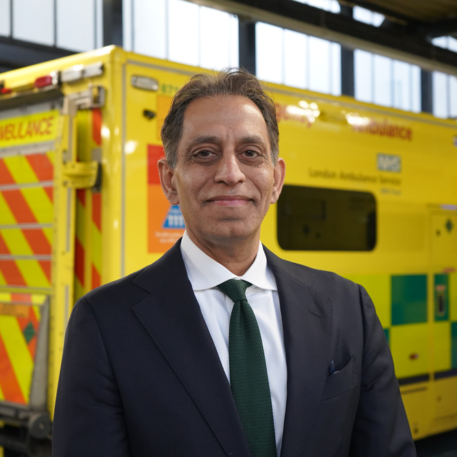 Gaurav Kumar standing in front of an ambulance.
