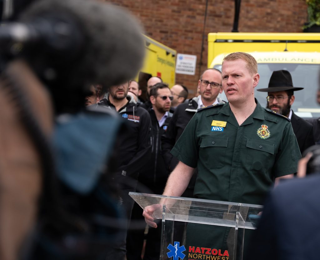 James Johnson shares a media update to press at a Hatzola Ambulance station.