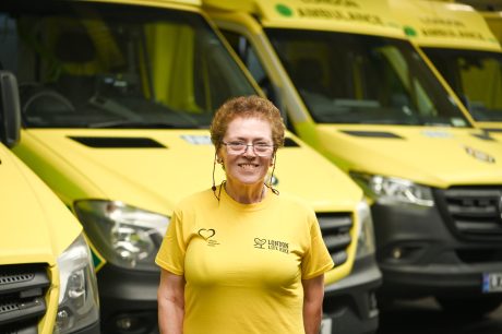 Carolyn standing in front of ambulances