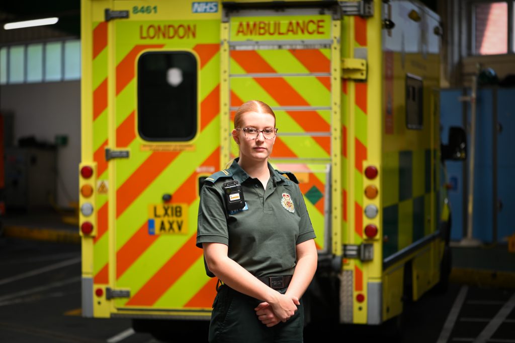 Paramedic Ella Johnson standing in front of an ambulance