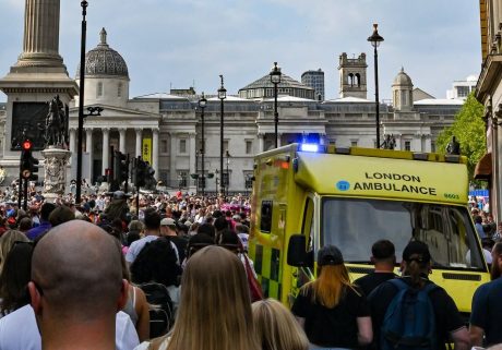 Ambulance in crowd of people at Trafalgar Square
